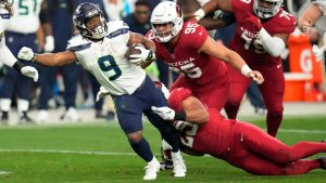 Seattle Seahawks running back Kenneth Walker III (9) is stopped by Arizona Cardinals linebacker Zaven Collins (25) in the second half of an NFL football game Sunday, Jan. 7, 2024, in Glendale, Ariz. (Ross D. Franklin/AP)