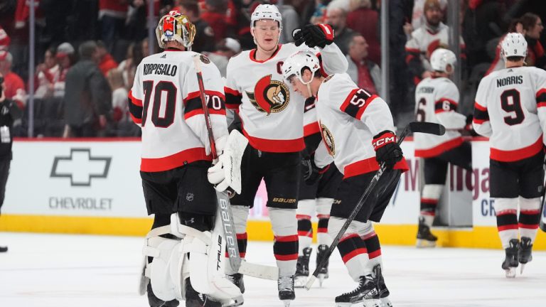 Ottawa Senators centre Shane Pinto (57) celebrates with Brady Tkachuk (7) and goaltender Joonas Korpisalo (70) after scoring against the Detroit Red Wings during overtime in an NHL hockey game Wednesday, Jan. 31, 2024, in Detroit. (Paul Sancya/AP)