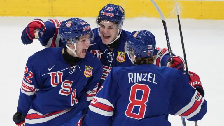 Team USA's Isaac Howard (22) celebrates his second goal of the game on Sweden goaltender Hugo Havelid (not shown) with teammates during second period gold medal hockey action at the IIHF World Junior Hockey Championship in Gothenburg, Sweden, Friday, Jan. 5, 2024. (CP)