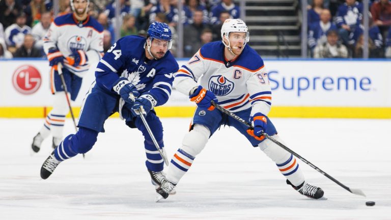 Toronto Maple Leafs centre Auston Matthews (34) chases Edmonton Oilers centre Connor McDavid (97) during first period NHL hockey action in Toronto. (Cole Burston/CP)