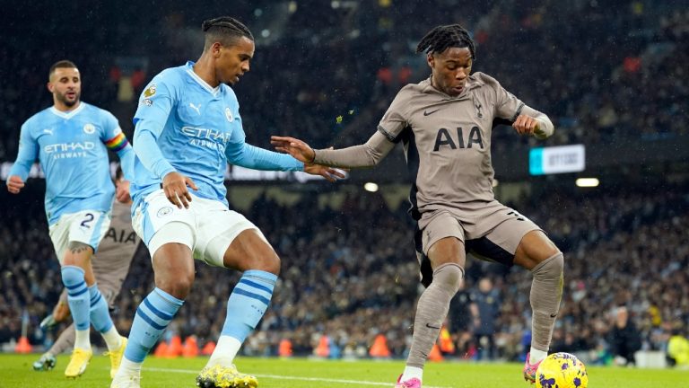 Tottenham's Destiny Udogie, right, controls the ball next to Manchester City's Manuel Akanji during the English Premier League soccer match between Manchester City and Tottenham Hotspur at Etihad stadium in Manchester, England, Sunday, Dec. 3, 2023. (Dave Thompson/AP)