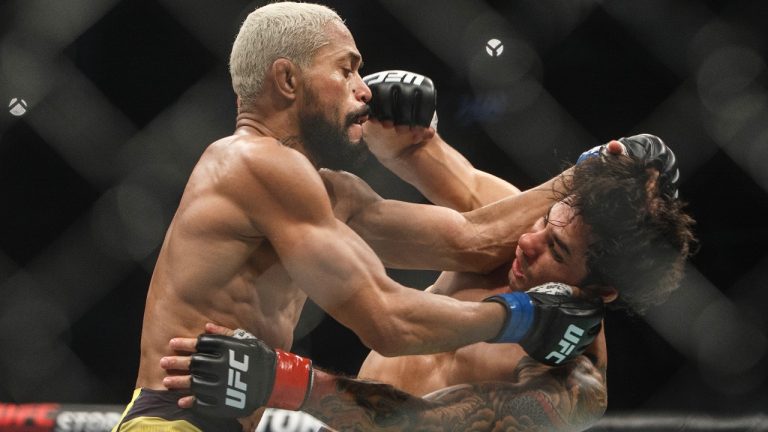 Alexandre Pantoja is hit by Deiveson Figueiredo during UFC 240, in Edmonton on Saturday, July 27, 2019. THE CANADIAN PRESS/Jason Franson