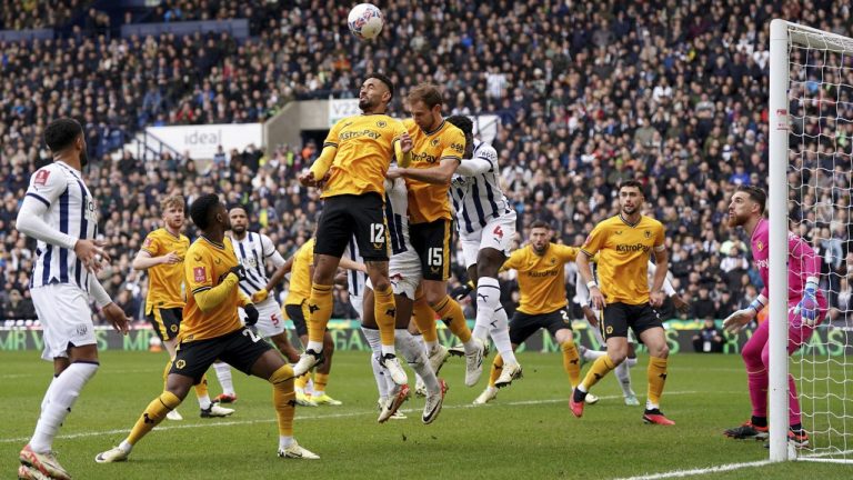 Wolverhampton Wanderers' Matheus Cunha, centre, heads clear from a corner, during the English FA Cup fourth round soccer match between West Bromwich Albion and Wolverhampton Wanderers, at The Hawthorns, in West Bromwich, England, Sunday, Jan. 28, 2024. (Bradley Collyer/PA via AP)