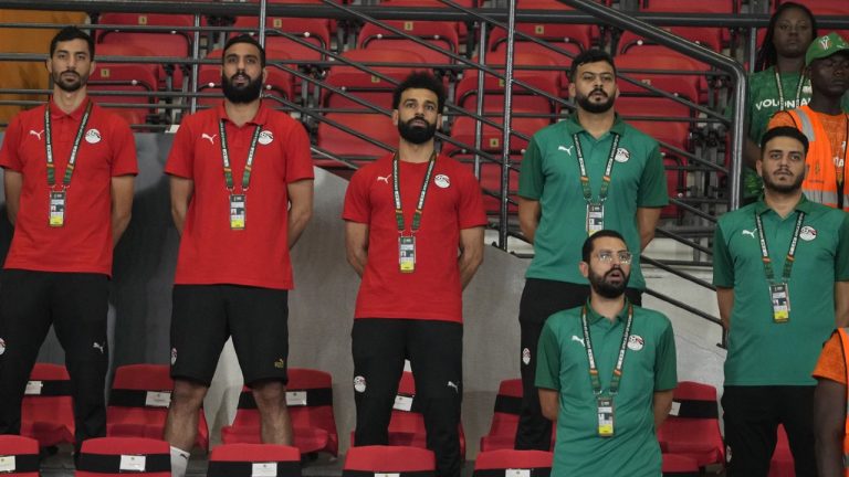 Egypt's injured player Mohamed Salah, centre, stands on the bench before the African Cup of Nations Group B soccer match between Cape Verde and Egypt at the Felix Houphouet Boigny stadium in Abidjan, Ivory Coast, Monday, Jan. 22, 2024. (Themba Hadebe/AP)