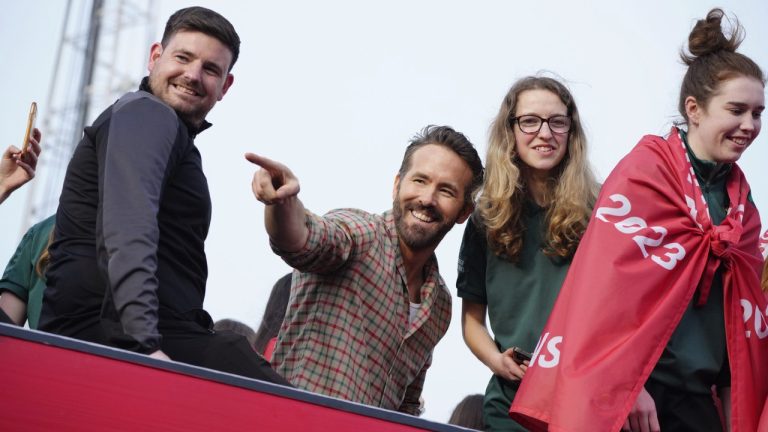 Wrexham co-owner Ryan Reynolds, centre, celebrates with members of the Wrexham FC soccer team the promotion to the Football League in Wrexham, Wales, on May 2, 2023. (Jon Super/AP)