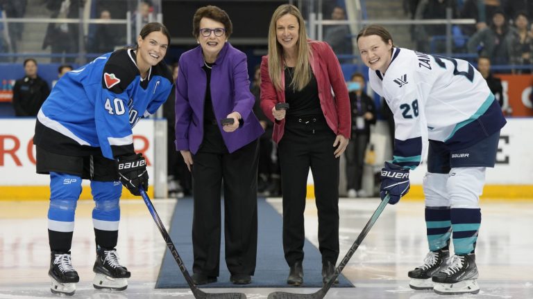 PWHL board member Billie Jean King (centre left) and PWHL executive Jayna Hefford prepare to drop pucks between Toronto captain Blayre Turnbull (left) and New York captain Micah Zandee-Hart (right) for the ceremonial faceoff before the inaugural PWHL game in Toronto on Monday, Jan. 1, 2024.  (Frank Gunn/CP)