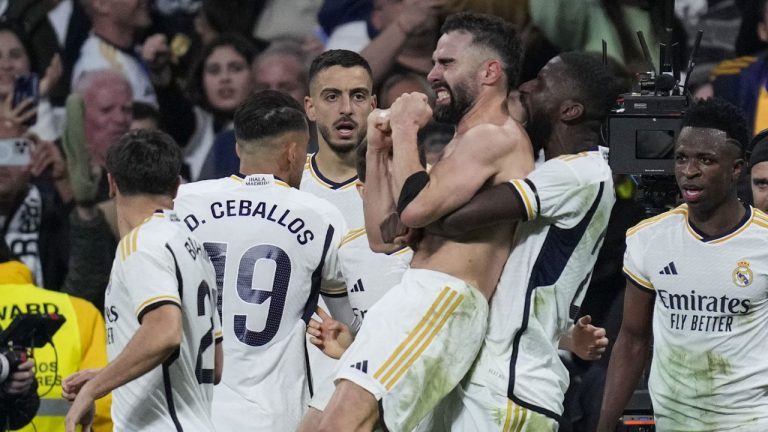 Real Madrid's Dani Carvajal celebrates with teammates after scoring his side's third goal during a Spanish La Liga soccer match between Real Madrid and Almeria at the Santiago Bernabeu stadium in Madrid, Spain, Sunday, Jan. 21, 2024. (Bernat Armangue/AP)