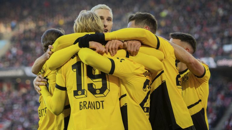 Dortmund players celebrate Donyell Malen's goal, during the German Bundesliga soccer match between Borussia Dortmund and FC Cologne, in Cologne, Germany, Saturday, Jan. 20, 2024. (Rolf Vennenbernd via AP)