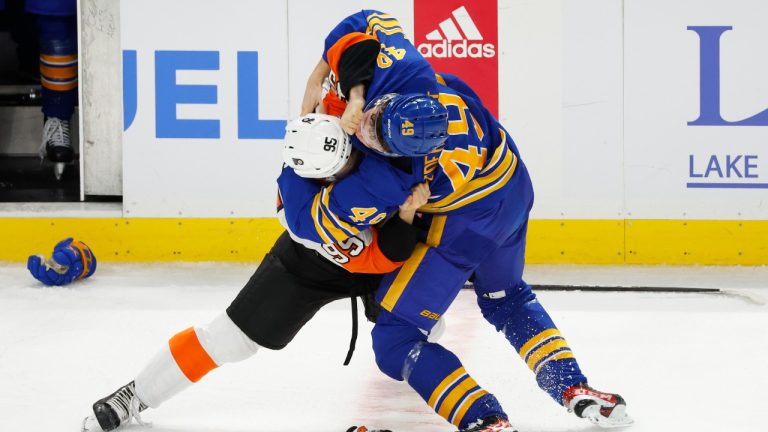 Philadelphia Flyers defenseman Adam Karashik (95) and Buffalo Sabres left wing Filip Cederqvist (49) fight during the third period of an NHL preseason hockey game, Tuesday, Sept. 27, 2022, in Buffalo, N.Y. (Jeffrey T. Barnes/AP Photo)