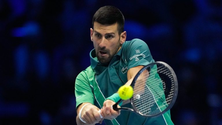 Serbia's Novak Djokovic returns the ball to Poland's Hubert Hurkacz during their singles tennis match of the ATP World Tour Finals at the Pala Alpitour, in Turin, Italy, Thursday, Nov. 16, 2023. (Antonio Calanni/AP)