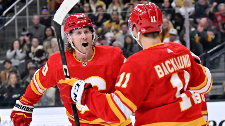 Calgary Flames center Blake Coleman (20) and center Mikael Backlund (11) celebrate a goal against the Vegas Golden Knights during the first period of an NHL hockey game Saturday, Jan. 13, 2024, in Las Vegas. (David Becker/AP)