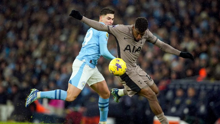 Manchester City's Julian Alvarez vies for the ball with Tottenham's Emerson Royal, right, during the English Premier League soccer match between Manchester City and Tottenham Hotspur at Etihad stadium in Manchester, England, Sunday, Dec. 3, 2023. (Dave Thompson/AP)