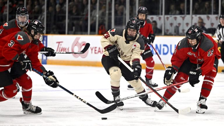 Ottawa's Zoe Boyd (3) and Brianne Jenner (19) take the puck from Montreal's Marie-Philip Poulin (29) during first period PWHL hockey action in Ottawa, Tuesday, Jan. 2, 2024. (Justin Tang/THE CANADIAN PRESS)