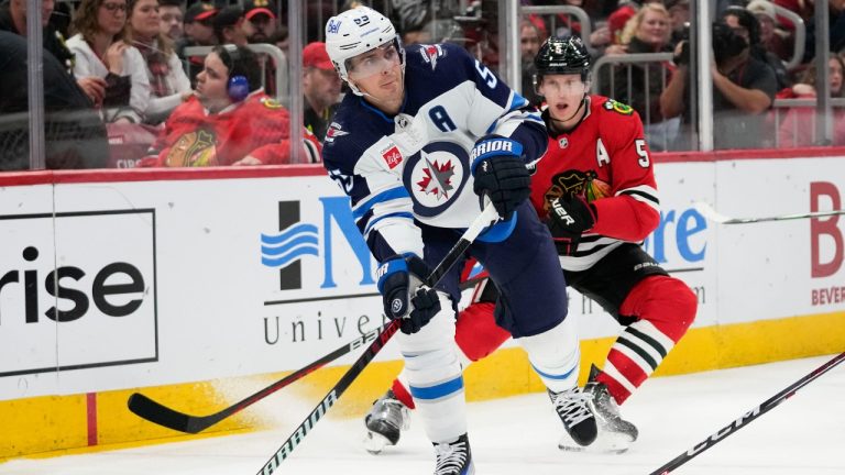 Winnipeg Jets center Mark Scheifele passes the puck during the second period of the team's NHL hockey game against the Chicago Blackhawks on Wednesday, Dec. 27, 2023, in Chicago. (Erin Hooley/AP)