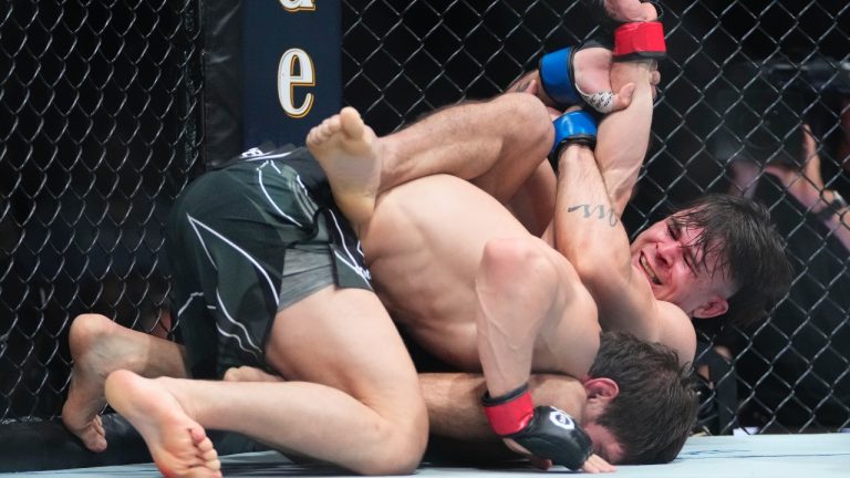 Brazil's Diego Lopes, right, grapples with Russia's Movsar Evloev during the third round of a featherweight bout at the UFC 288 mixed martial arts event Saturday, May 6, 2023 in Newark, N.J. Evloev won the fight. (AP Photo/Frank Franklin II)