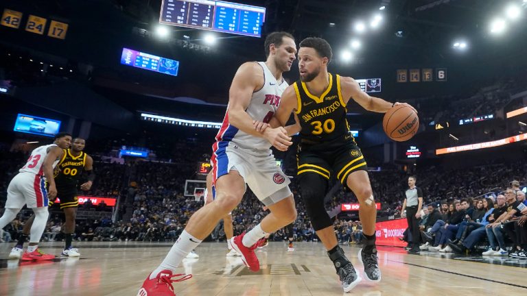 Golden State Warriors guard Stephen Curry (30) drives to the basket against Detroit Pistons forward Bojan Bogdanovic during the first half of an NBA basketball game in San Francisco, Friday, Jan. 5, 2024. (Jeff Chiu/AP)