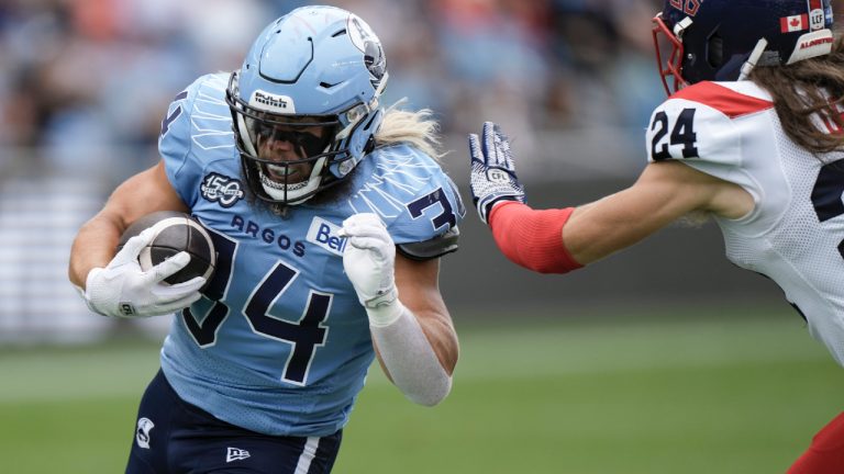 A.J. Ouellette (34) is chased by Montreal Alouettes defensive back Marc-Antoine Dequoy (24) during second half CFL football action in Toronto, Saturday, Sept. 9, 2023. (Arlyn McAdorey/CP)