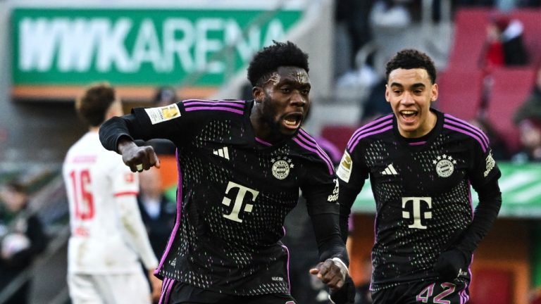 Munich's Alphonso Davies, left, celebrates scoring with teammate Jamal Musiala during the Bundesliga soccer match between FC Augsburg and Bayern Munich at the WWK-Arena, Augsburg, Germany, Saturday Jan. 27, 2024. (Sven Hoppe/dpa via AP)