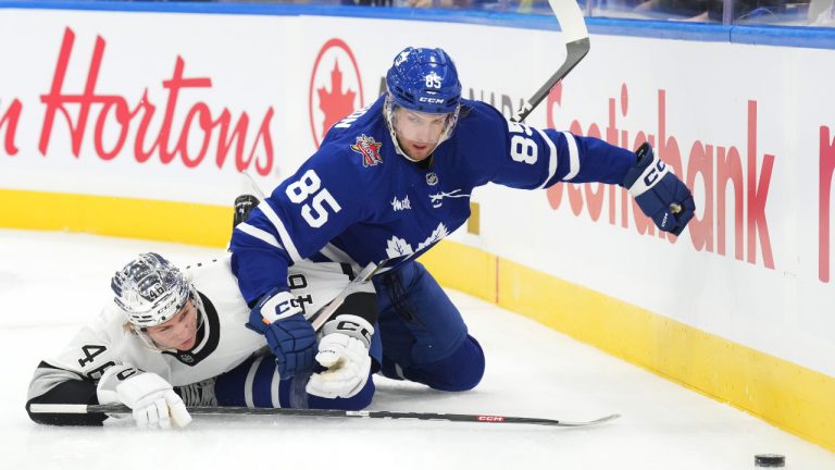 Toronto Maple Leafs' William Lagesson and Los Angeles Kings' Blake Lizotte battle for the puck during first period NHL hockey action in Toronto, on Tuesday, October 31, 2023. (Chris Young/CP)