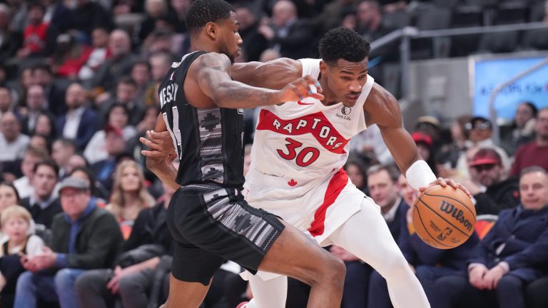 Toronto Raptors' Ochai Agbaji drives past San Antonio Spurs' Blake Wesley during second  half NBA basketball action in Toronto on Monday, February 12, 2024. THE CANADIAN PRESS/Chris Young