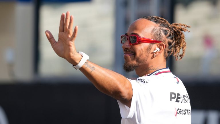 FILE - Mercedes driver Lewis Hamilton of Britain, waves as he arrives for the F1 drivers group picture ahead the drivers parade prior to the Abu Dhabi Formula One Grand Prix at the Yas Marina racetrack in Abu Dhabi, United Arab Emirates, Sunday, Nov. 26, 2023. (Kamran Jebreili/AP) 