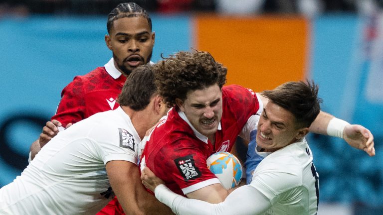 Argentina's Santiago Alvarez, left, and Marcos Moneta, right, tackle Canada's David Richard as Josiah Morra watches from behind during Vancouver Sevens rugby action, in Vancouver, on Friday, Feb. 23, 2024. (Ethan Cairns/CP)