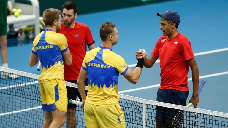 Rajeev Ram, right, and Austin Krajicek of the USA shake hands after their victory to Illya Beloborodko, left, and Oleksii Krutykh of Ukraine during a Davis Cup qualifier doubles tennis match between Ukraine and USA, in Vilnius, Lithuania, Friday, Feb. 2, 2024. (AP Photo/Mindaugas Kulbis)