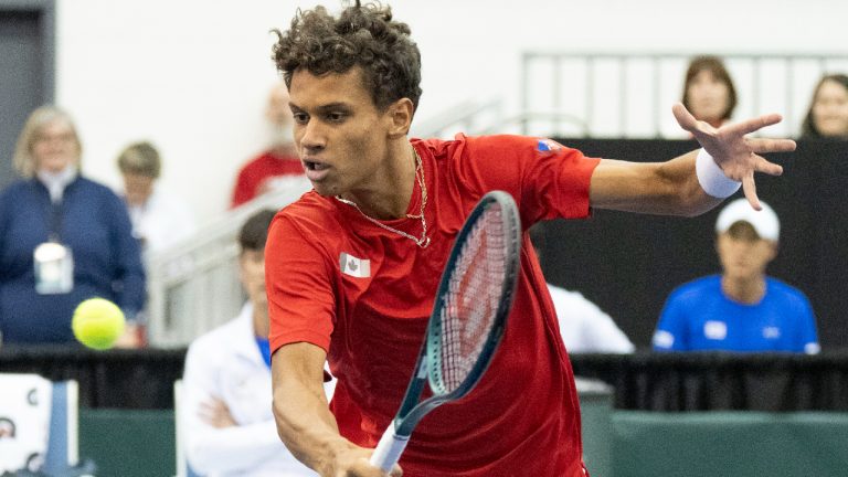 Gabriel Diallo, of Canada, hits a return to Kwon Soonwoo, of South Korea, during the first singles match of the Davis Cup tennis qualifiers in Montreal, Friday, Feb. 2, 2024. (Christinne Muschi/CP)