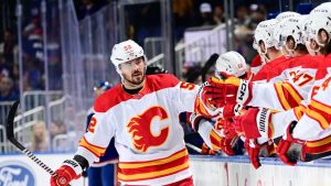 MacKenzie Weegar #52 of the Calgary Flames is congratulated by his teammates after scoring a goal against the New York Islanders during the first period at UBS Arena on February 10, 2024 in Elmont, New York. (Photo by Steven Ryan/NHLI via Getty Images)