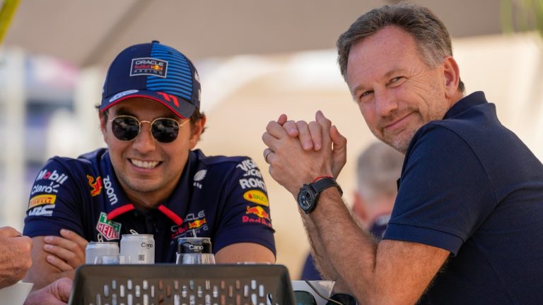 Red Bull team principal Christian Horner, right, chats with Red Bull driver Sergio Perez of Mexico at the pits during Formula One pre season test at the Bahrain International Circuit in Sakhir, Bahrain, Wednesday, Feb. 21, 2024. (Darko Bandic/AP)