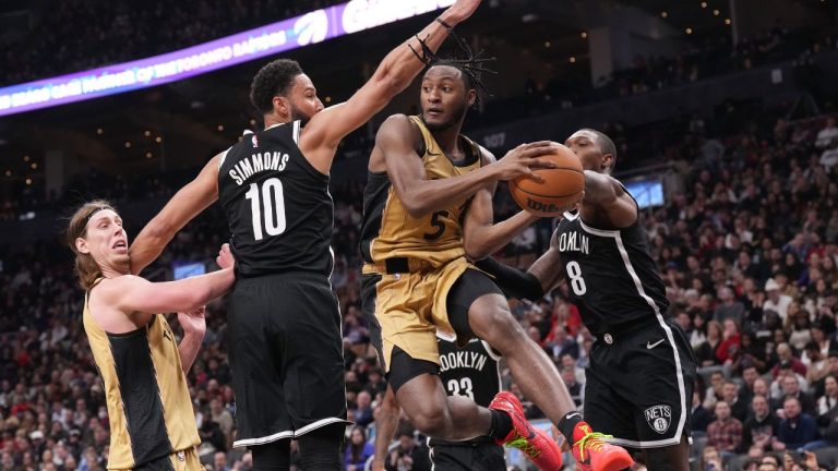 Toronto Raptors' Immanuel Quickley looks to pass around Brooklyn Nets' Ben Simmons during second half NBA basketball action in Toronto on Thursday, February 22, 2024. (Chris Young/CP Photo)