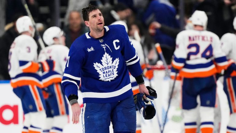 Toronto Maple Leafs' John Tavares skates off the ice as the New York Islanders celebrate their win in NHL hockey action in Toronto on Monday, February 5, 2024. (Frank Gunn/CP Photo)