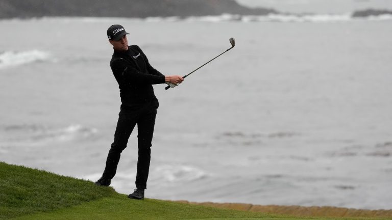 Justin Thomas hits toward the 18th green at Pebble Beach Golf Links during the third round of the AT&T Pebble Beach National Pro-Am golf tournament. (Ryan Sun/AP)