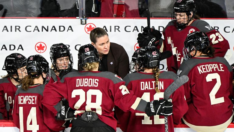 PWHL Montreal head coach Kori Chevrie talks to players during the first period of a home game against Minnesota in mid-February. (Photo by Graham Hughes/CP)