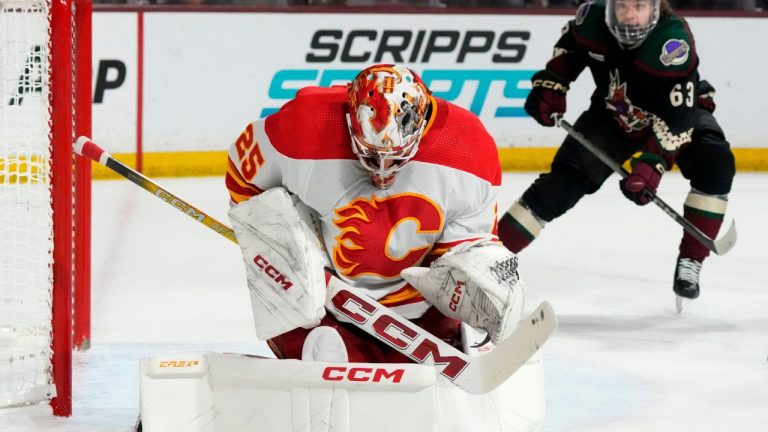 Calgary Flames goaltender Jacob Markstrom makes a save as Arizona Coyotes left wing Matias Maccelli waits for a possible rebound during the first period of an NHL hockey game Thursday, Jan. 11, 2024, in Tempe, Ariz. (Ross D. Franklin/AP Photo)