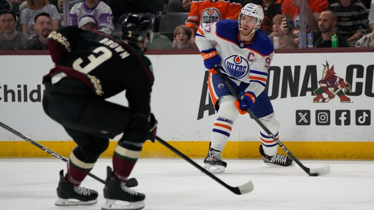 Edmonton Oilers centre Connor McDavid looks to pass in front of Arizona Coyotes defenseman Josh Brown in the first period during an NHL hockey game, Monday, Feb. 19, 2024, in Tempe, Ariz. (Rick Scuteri/AP)