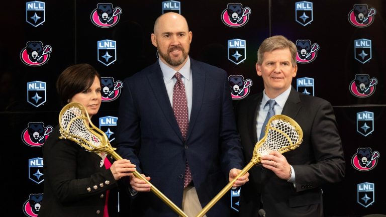 National Lacrosse League Commissioner Brett Frood (centre) poses with GF Sports and Entertainment's Erik Baker (right) and Senators Sports & Entertainment COO & CFO Erin Crowe after announcing the Ottawa Black Bears, Wednesday, February 21, 2024 in Ottawa. (Adrian Wyld/CP)