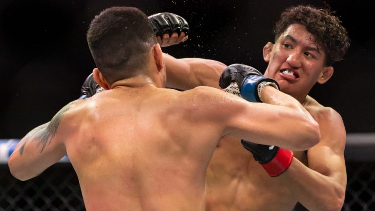 Raul Rosas Jr., right, and Christian Rodriguez fight in their bantamweight title match during the UFC 287 event at the Kaseya Center on Saturday, April 8, 2023, in downtown Miami. (Matias J. Ocner/Miami Herald via AP)