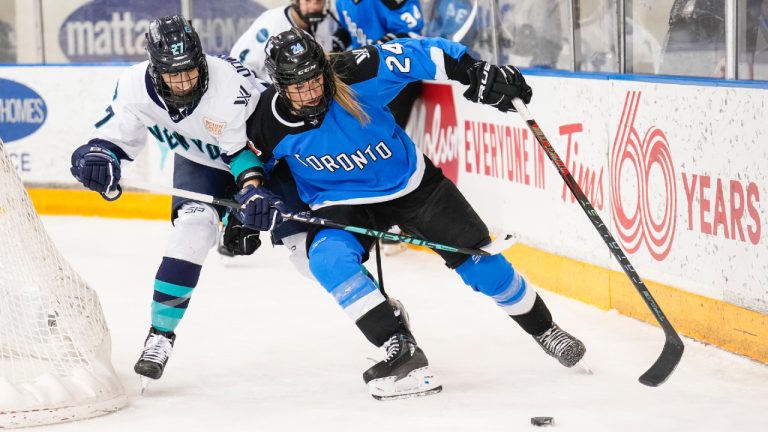 Toronto's Natalie Spooner (24) battles for the puck against New York's Jade Downie-Landry (27) during second period PWHL action in Toronto on Friday, Feb. 23, 2024. (Andrew Lahodynskyj/CP)