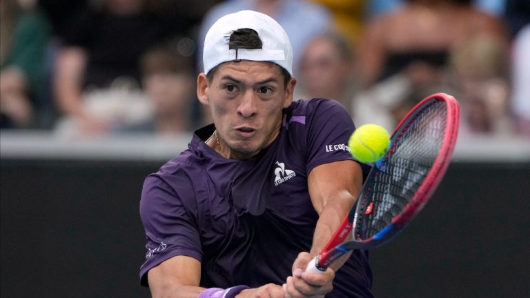 Sebastian Baez of Argentina plays a backhand return to Jannik Sinner of Italy during their third round match at the Australian Open tennis championships at Melbourne Park, Melbourne, Australia, Friday, Jan. 19, 2024. (Andy Wong/AP)