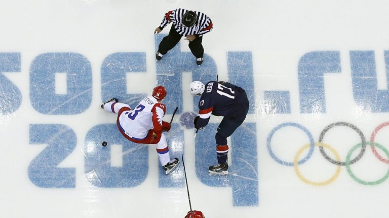 FILE - Russia forward Pavel Datsyuk and USA forward Ryan Kesler face off to start a men's ice hockey game at the 2014 Winter Olympics, Saturday, Feb. 15, 2014, in Sochi, Russia. (Julio Cortez/AP)