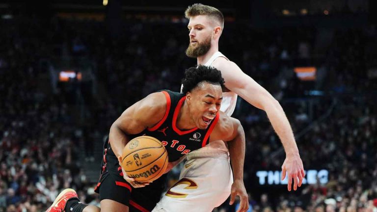 Toronto Raptors forward Scottie Barnes (left) is fouled by Cleveland Cavaliers forward Dean Wade (32) during first half NBA basketball action in Toronto. (Frank Gunn/THE CANADIAN PRESS)