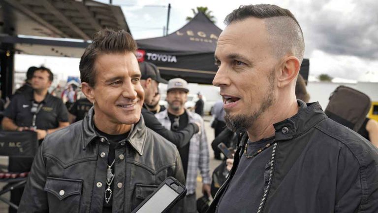 Scott Stapp, left, and Mark Tremonti, right, members of the rock band Creed, take part in an interview during an NASCAR Daytona 500 practice auto race Thursday, Feb. 15, 2024, at Daytona International Speedway. (Chris O'Meara/AP)