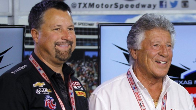 Michael Andretti, left, and his father, Mario Andretti, pose for a photo following a news conference at Texas Motor Speedway in Fort Worth, Texas, June 7, 2013. (AP Photo/Tim Sharp)