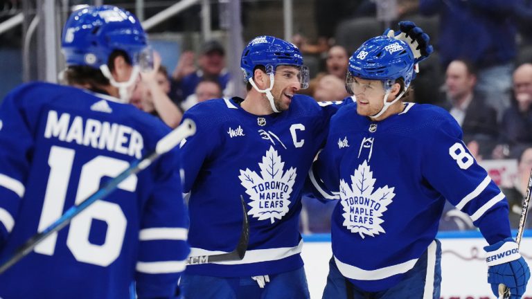 Toronto Maple Leafs forward John Tavares (91) celebrates his goal against the Dallas Stars with forward William Nylander (88) during second period NHL hockey action in Toronto on Wednesday, February 7, 2024. (Nathan Denette/CP)