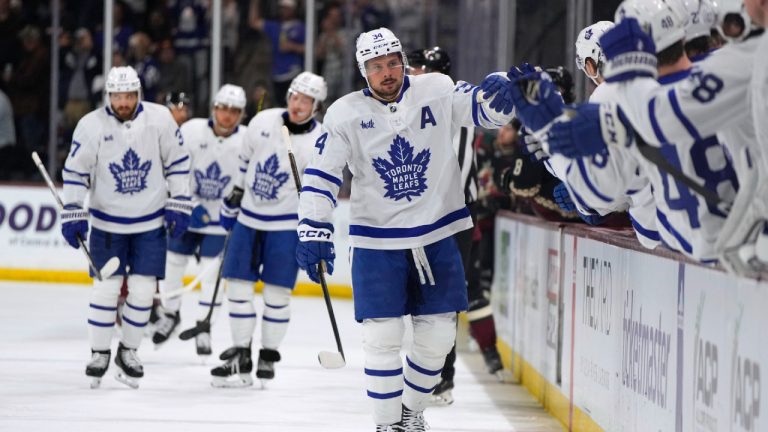 Toronto Maple Leafs centre Auston Matthews (34) is congratulated after scoring his 50th goal of the season, against the Arizona Coyotes during the first period of an NHL hockey game Wednesday, Feb. 21, 2024, in Tempe, Ariz. (Rick Scuteri/AP)