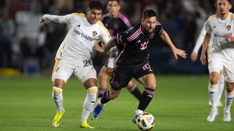 Inter Miami forward Lionel Messi (10) dribbles the ball past Los Angeles Galaxy midfielder Edwin Cerrillo (20) during the first half of an MLS soccer match, Saturday, Feb. 25, 2024, in Carson, Calif. (Kyusung Gong/AP)