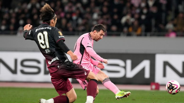 Inter Miami's Lionel Messi, right, battles for the ball against Vissel Kobe's Ryuho Kikuchi during the friendly soccer match between Vissel Kobe and Inter Miami CF at the National Stadium, Wednesday, Feb. 7, 2024, in Tokyo, Japan. (Eugene Hoshiko/AP)