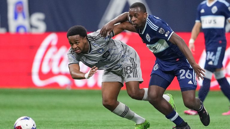 CF Montreal's Rida Zouhir (18) and Vancouver Whitecaps' J.C. Ngando (26) vie for the ball during the second half of an MLS soccer game in Vancouver, on Saturday, April 1, 2023. (Darryl Dyck/CP)