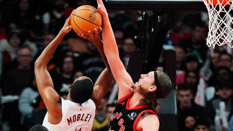 Cleveland Cavaliers forward Evan Mobley (4) is blocked by Toronto Raptors forward Kelly Olynyk (41) during first half NBA basketball action. (Frank Gunn/THE CANADIAN PRESS)